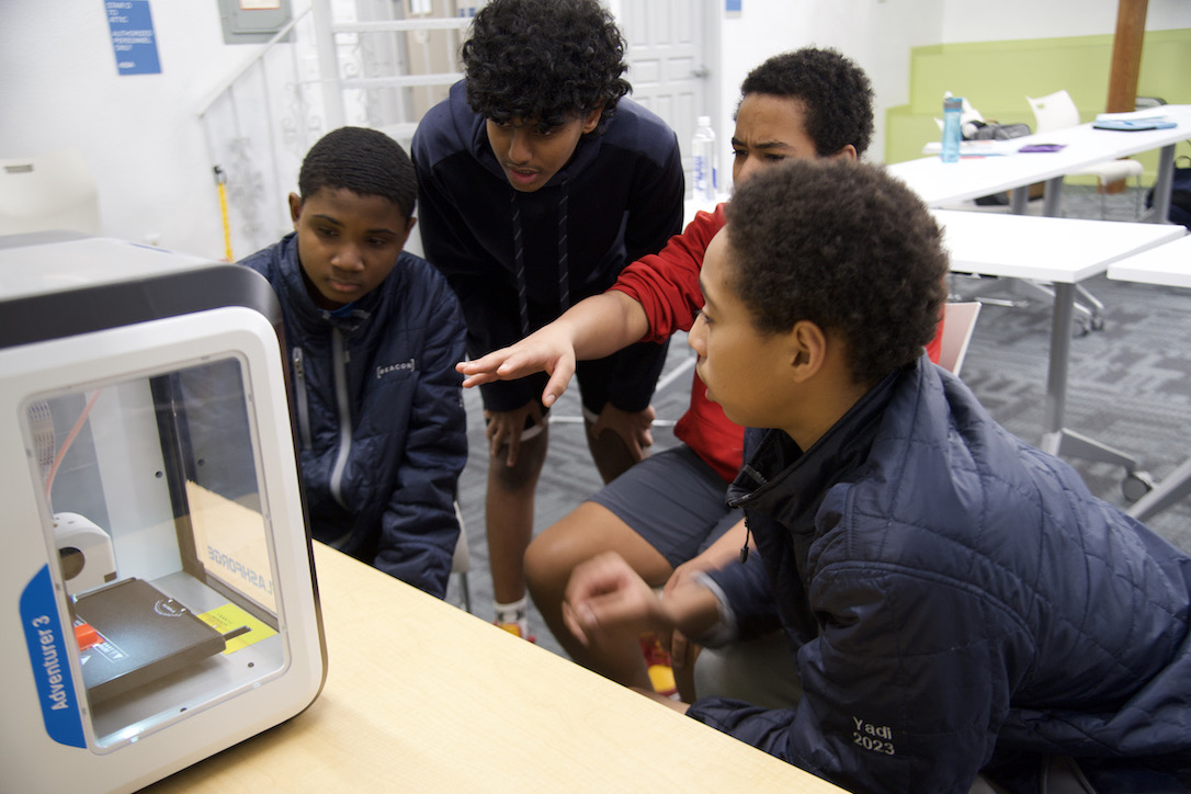 school students using a 3d printer