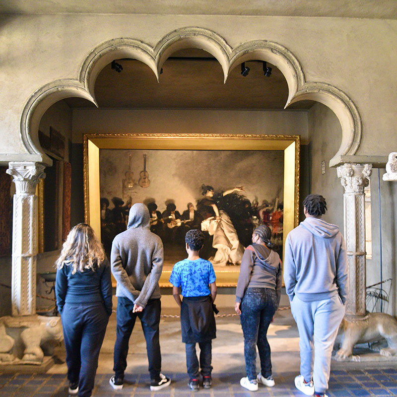 school students looking at painting