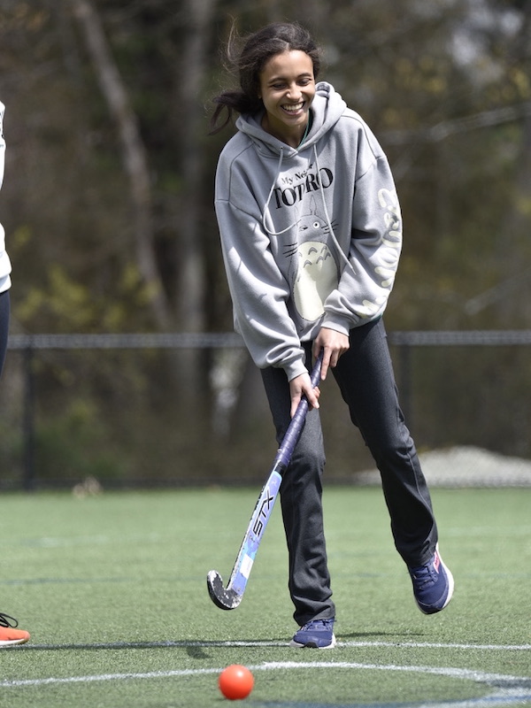 students playing field hockey