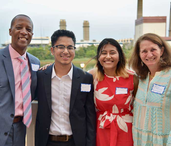 faculty and students smiling