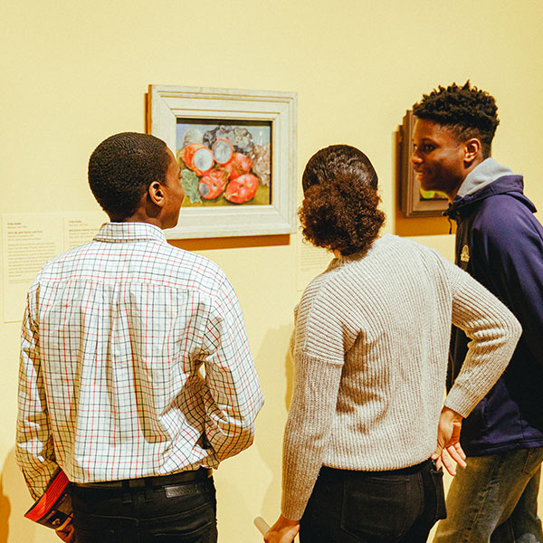 students looking at artwork in museum